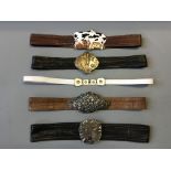 Five brown, black and white leather belts, four with silver clasps in various designs including