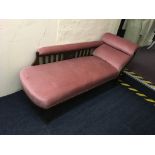 A pink upholstered chaise longue.