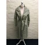 A Jean Muir light green collared leather coat with zig zag hole punch design to edges and belt.
