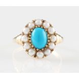 *A 9ct yellow gold turquoise and split pearl ring, set with a central oval turquoise cabochon,