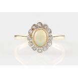 *An 18ct yellow gold opal and diamond ring, set with a central oval opal cabochon surrounded by a