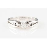 A diamond ring, set with a central round brilliant cut diamond, measuring approx. 0.17ct, with