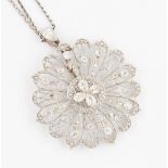A Belle Epoque diamond pendant, the open metalwork flower design set with four central old pear