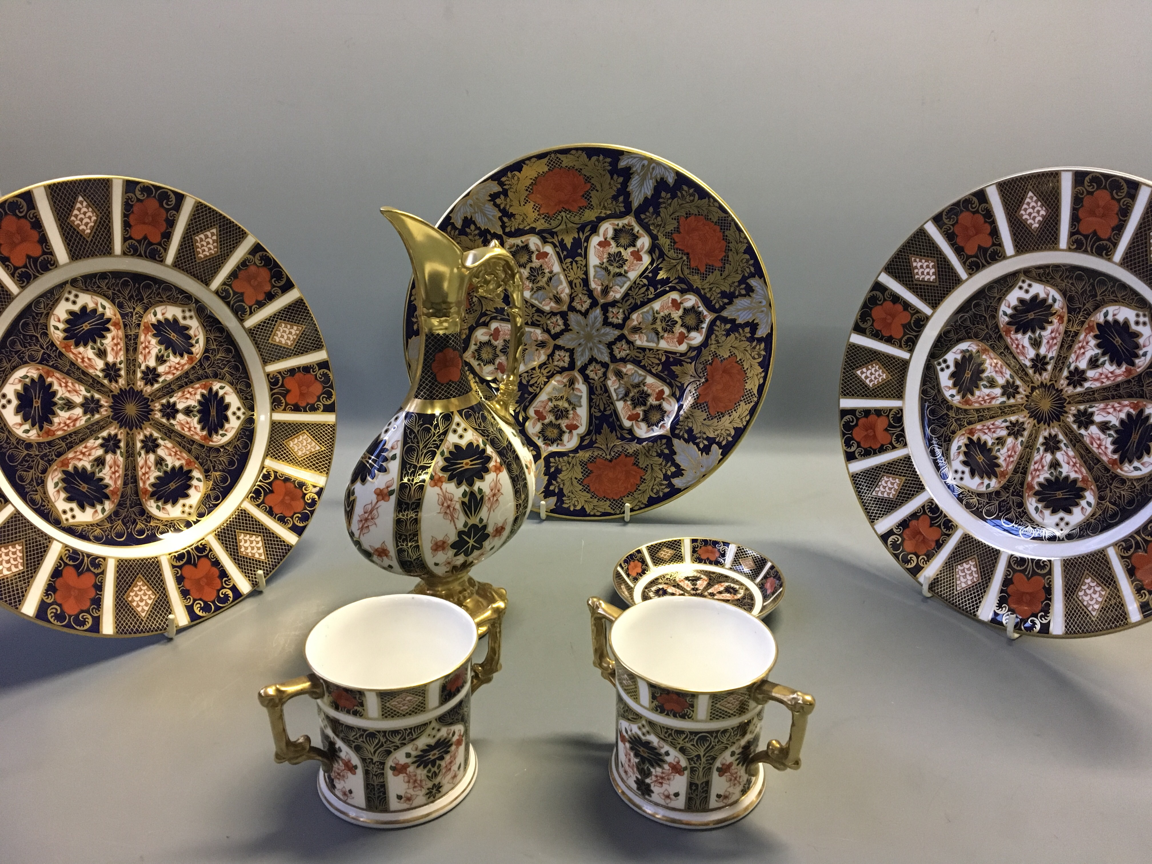 A selection of Royal Crown Derby Imari ware including two and one small plate, two mugs, one jug,