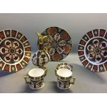 A selection of Royal Crown Derby Imari ware including two and one small plate, two mugs, one jug,