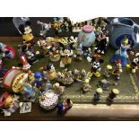 A selection of various Disney figurines including Mickey Mouse, Frozen money pot, Fiesta Bugs