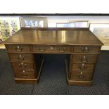 A mahogany Victorian desk with eight short and one long drawers.