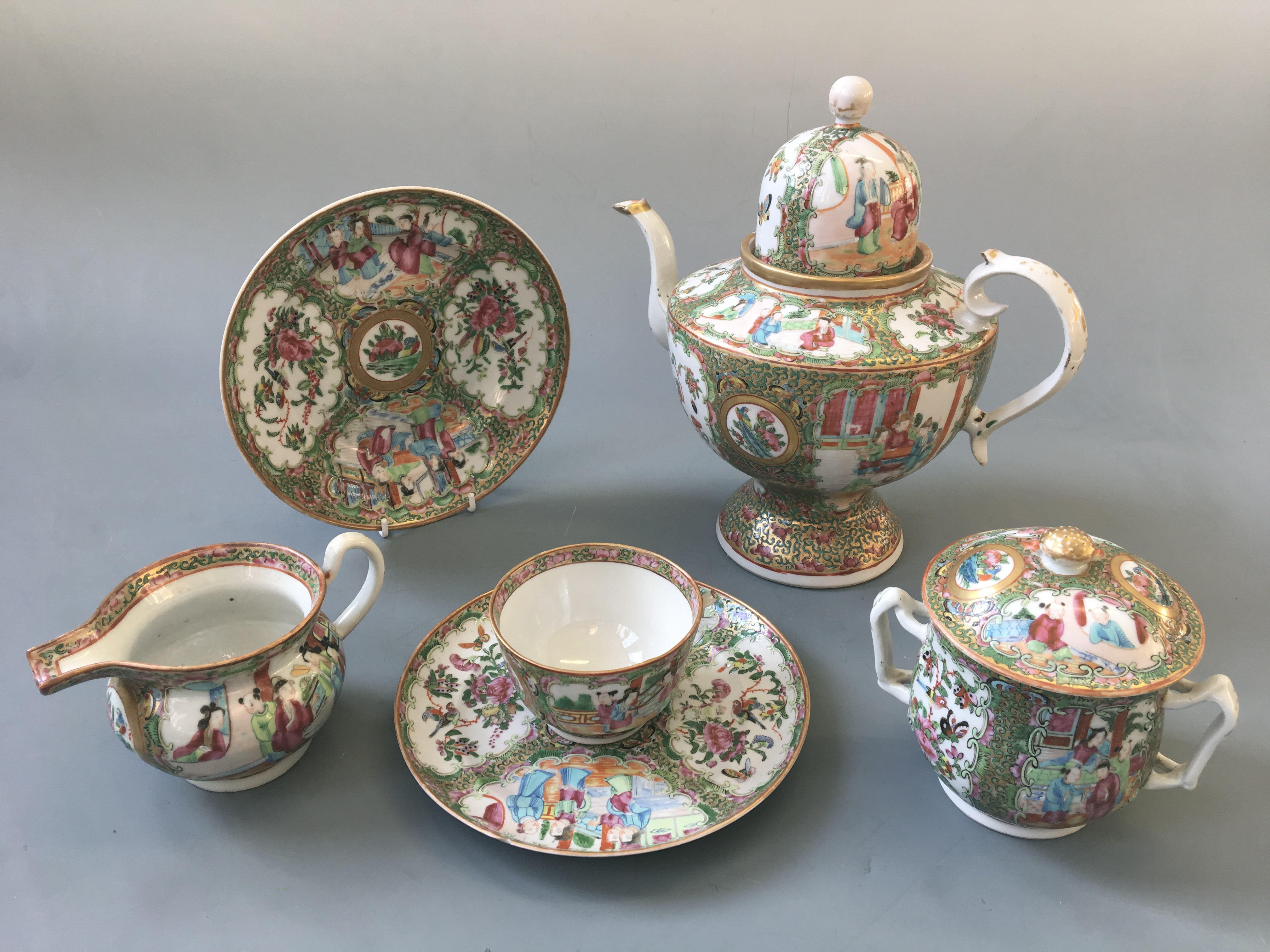 A Chinese hand painted design tea set including tea pot, jug, lidded pot, four small plates, two