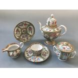 A Chinese hand painted design tea set including tea pot, jug, lidded pot, four small plates, two