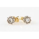 A pair of diamond stud earrings, each illusion set with a round brilliant cut diamond approx. 0.