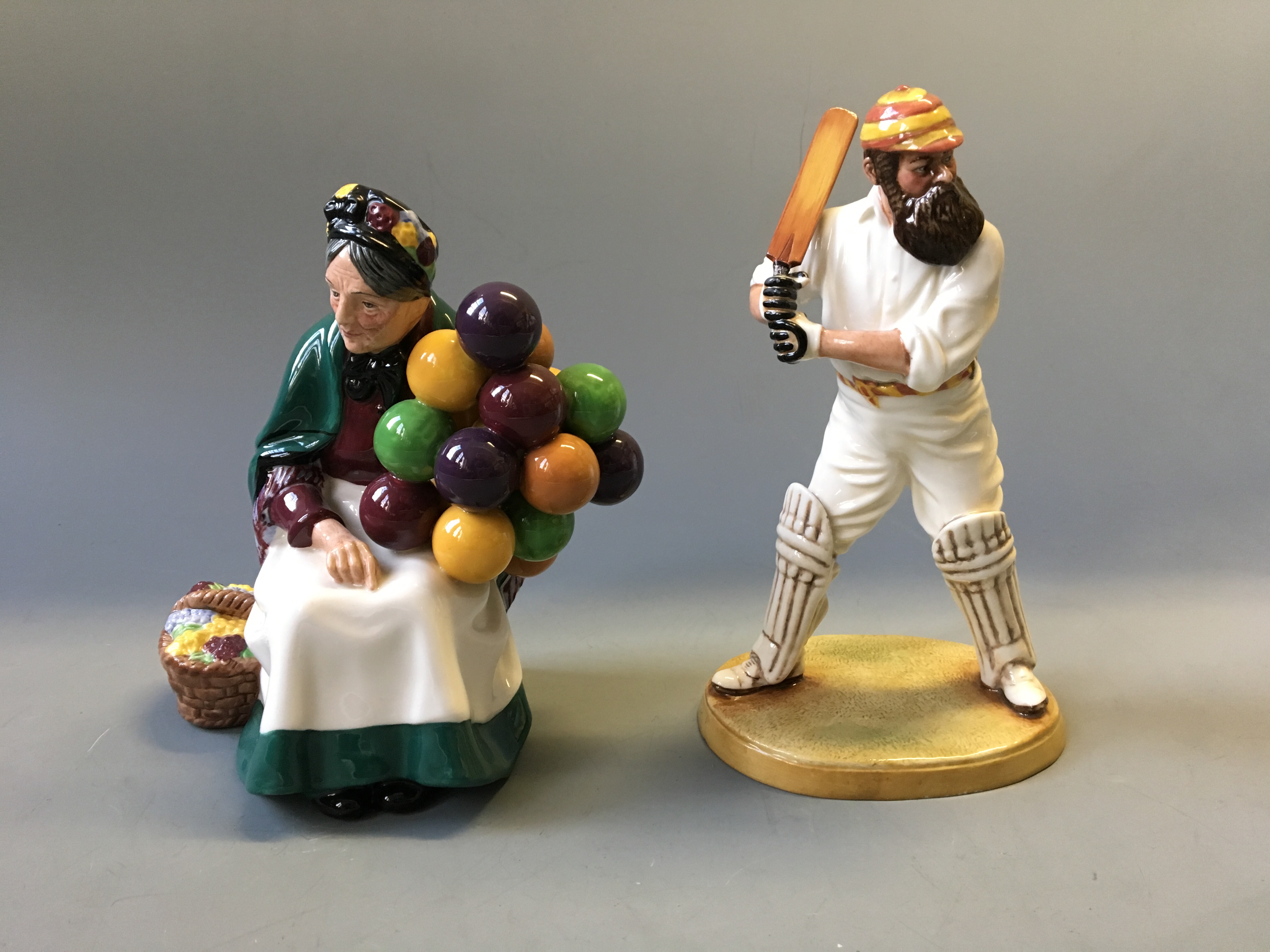 Two Royal Doulton figurines, Old Balloon Seller and limited edition W.G. Grace.