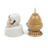Two tape measures comprising a continental porcelain example in the form of a Pierrot head with ruff