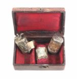 A silver sewing trio in leather case comprising a silver cylinder tape measure with complete printed