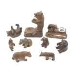 Nine carved wooden Tyrolean bears comprising a small desk stand fitted with a glass inkwell, 12cm, a