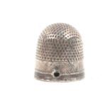 A mid 17th Century English silver thimble the plain frieze with the inverted initials ïMMÍ over a