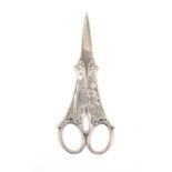 A pair of early 20th Century French white metal scissors, the tapering blades to pierced and