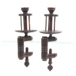A pair of rosewood winding clamps the turned rectangular frames below birdcage reels and cup tops,