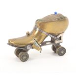 A brass and steel novelty tape measure/ pincushion in the form of a roller skate, tape shortened