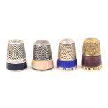 Four enamel decorated silver and white metal thimbles comprising a silver gilt example with purple