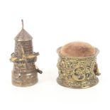 Two brass novelty tape measures comprising a windmill wound from the sails, 7cm, the other of floral