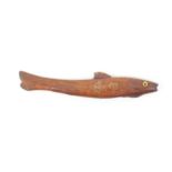 A 19th Century wooden fish form knitting stick in mahogany, glass eyes, initialled in brass pins