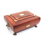 A Regency red leather covered sewing box of sarcophagal form, the stepped top with gilt brass corner