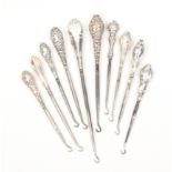 Ten silver handled button hooks, largest 28cm (10)