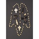 Seven charms and novelties all with Stanhopes comprising a bone rosary cross and beads (Sacre