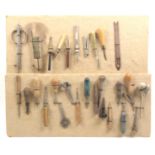 A collection of awls etc, wool and net hooks and stitchers mounted on two boards (2)