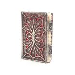 An 18th Century English silver filigree needlebook the cover and spine with panels of floral