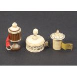 Three ivory tape measures comprising a carved boxwood and ivory example of vase form, complete