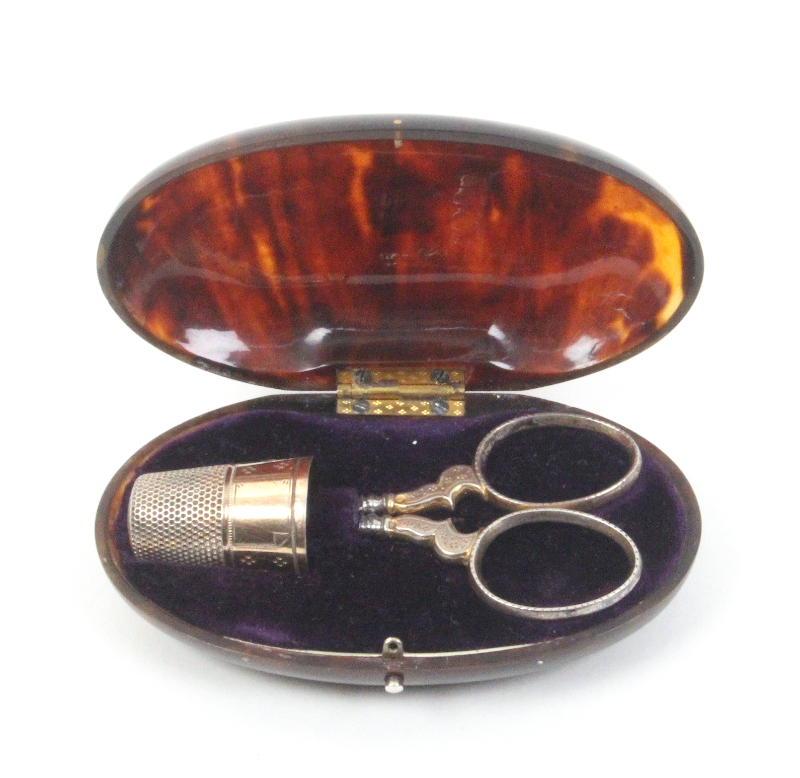 A tortoiseshell oval etui circa 1880, of oval form, the blue velvet flush fitted interior with a
