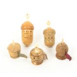 Three vegetable ivory tape measures and two thimble cases comprising a skep form example, printed