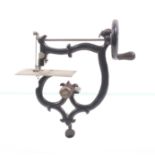 A late 19th Century miniature sewing machine with table clamp, black painted frame, platform stamped