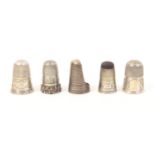 Five silver thimbles comprising a mid 19th Century example inscribed ïForget Me NotÍ over fancy rim,