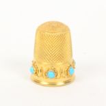 A Victorian gold thimble the frieze set with six turquoise coloured stones within a wirework band