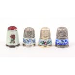 Four attractive silver and white metal enamel decorated thimbles comprising a silver example with