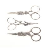 Three pairs of steel figural scissors comprising a pair with diamond section blades, the arms as a