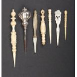 Seven stilettos comprising a reversible carved ivory example, pineapple style finial, 11.5cm,