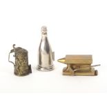 Three metal novelty tape measures comprising a brass anvil with hammer, 6.5cm, a beer stein embossed