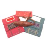 A leather knitterÍs belt or whisk, 90cm, and three cardboard knitting needle wallets, including ñThe