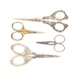 Four pair of scissors comprising a pair with silver arms and loops as angel heads, Birmingham, 1906,