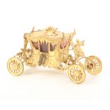 A good example of a gilded metal novelty tape measure in the form of the Coronation coach,