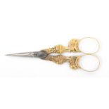 A fine pair of gold mounted French scissors, steel oval section tapering blades the gold arms