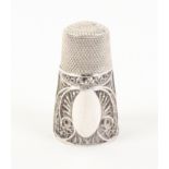 A good early 18th Century English silver filigree thimble in leather case, the thimble with deep