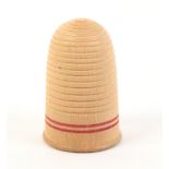 An early 19th Century turned whitewood Tunbridge ware thimble with red line painted frieze