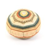 A late 18th Century pin ball decorated in brightly coloured threads in a geometric design, 4.7cm