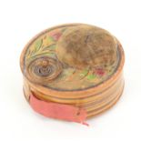 An early 19th Century print and paint decorated Tunbridge ware pincushion/tape measure of circular