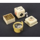 Four novelty celluloid tape measures comprising a chess/morris board, 3.2cm, a pail with