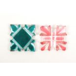 Two scarce glass silk winders one green tinted and cut through, mirror reverse, 2.6cm square and